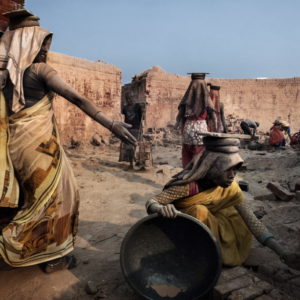 Varanasi, India. The young women wear inappropriate clothing and no protective mask to protect the respiratory system. No health safety measure , nor food and home is provided by the furnace managers.