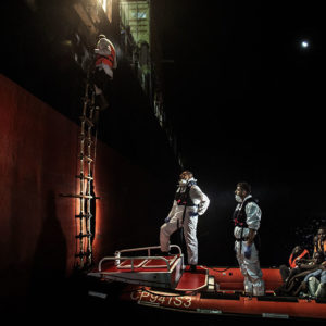 Mediterranean Sea, Italy. Some phases of the transshipment of 130 migrants from the Maltese cargo ship "Purkial" to the lifeboat of the Italian Coast Guard "Diciotti" ship. This occurred in the Libyan sea, in front of Misurata.